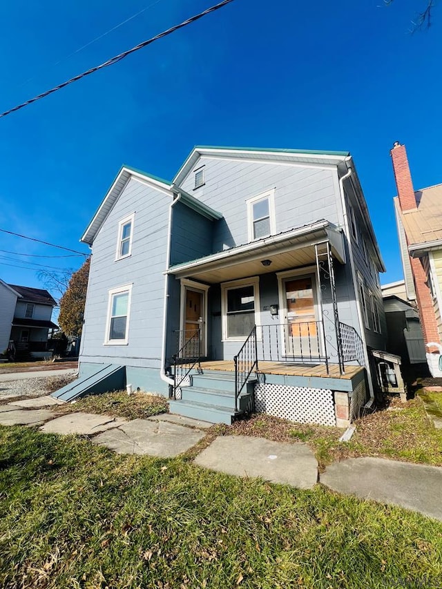 view of front of house with a front yard and covered porch