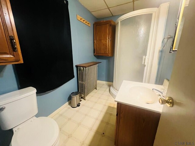 bathroom featuring vanity, toilet, and a drop ceiling