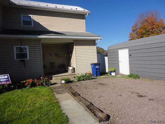 back of house featuring a yard and a shed