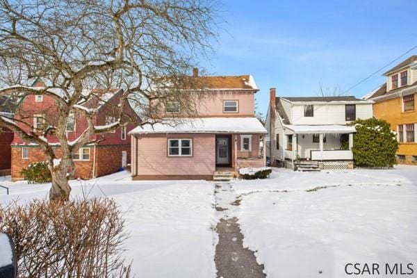 view of snow covered rear of property