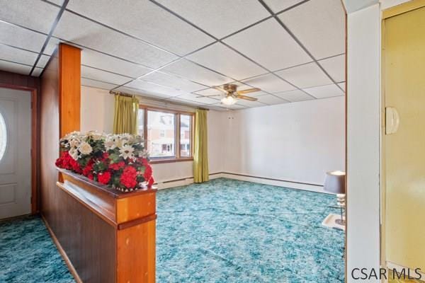 interior space featuring ceiling fan and baseboard heating