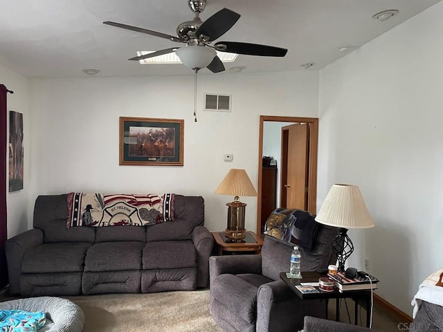 living room featuring visible vents, ceiling fan, and carpet floors