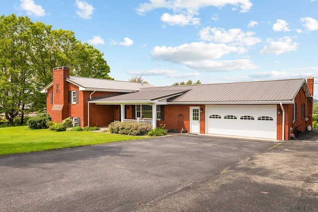 258 Samuels Rd, Somerset, PA 15501 - single story home with an attached garage, brick siding, a chimney, driveway, and a front yard