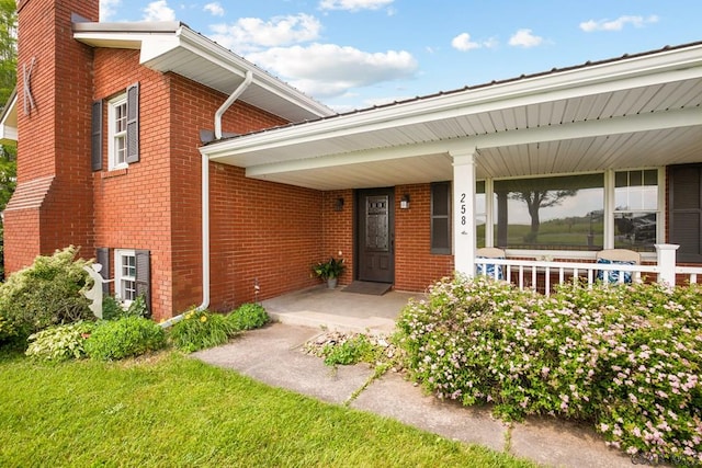 258 Samuels Rd, Somerset, PA 15501 - doorway to property with a chimney, covered porch, and brick siding
