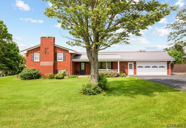 258 Samuels Rd, Somerset, PA 15501 - split level home featuring brick siding, an attached garage, asphalt driveway, a porch, and a metal roof