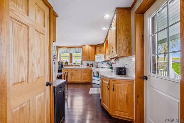 1139 Chickentown Rd, Somerset, PA 15501 - kitchen with light countertops, backsplash, white microwave, range with gas stovetop, and dark wood-style flooring