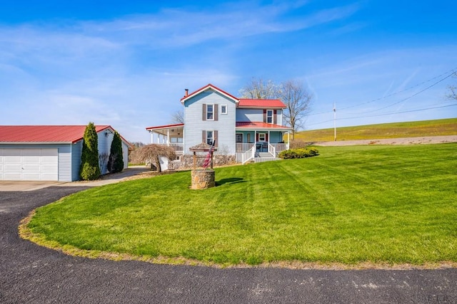1139 Chickentown Rd, Somerset, PA 15501 - view of front of property with metal roof, a front yard, a detached garage, and covered porch