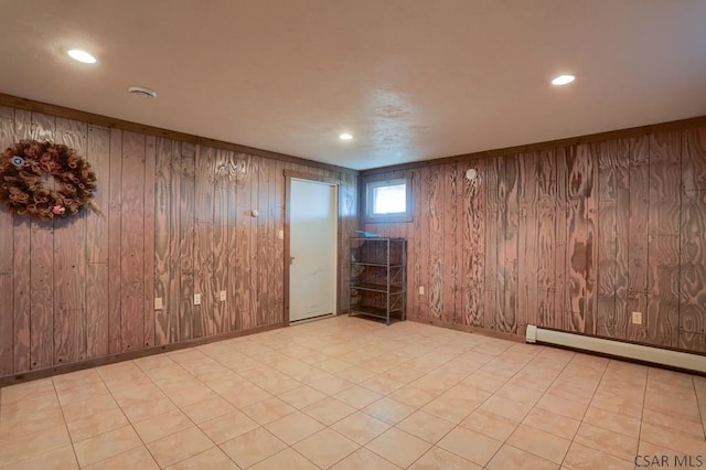 spare room featuring wooden walls, recessed lighting, a baseboard heating unit, and baseboards