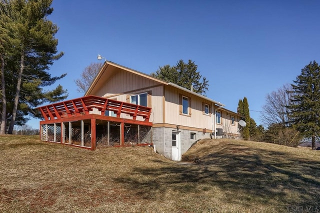 back of house with a lawn and a wooden deck