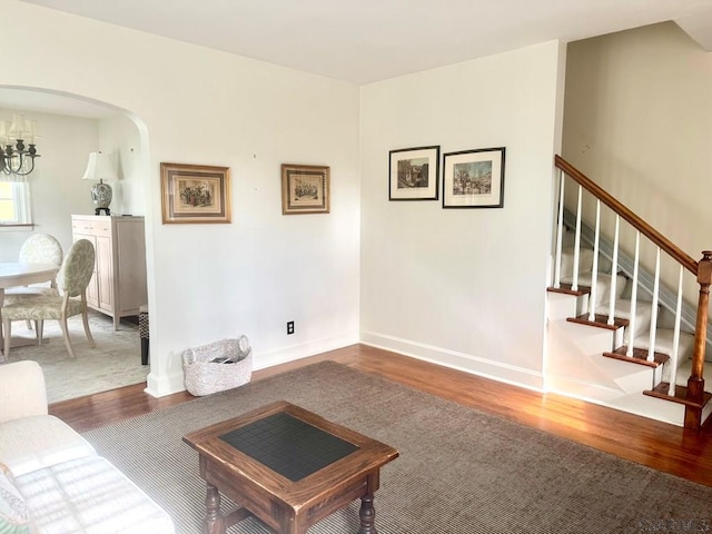 living room with hardwood / wood-style floors and an inviting chandelier