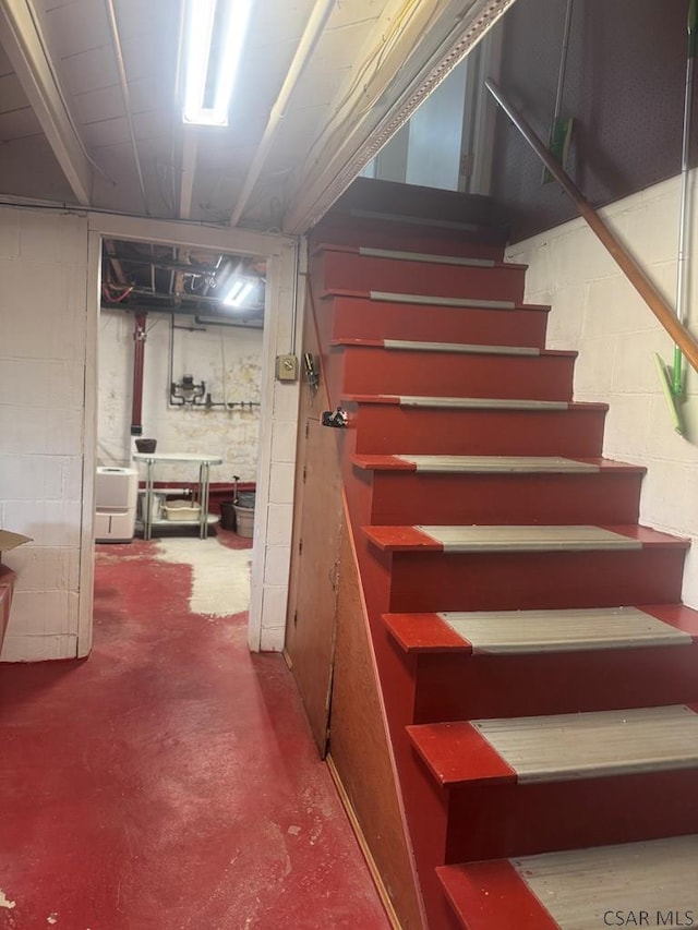 stairway with concrete flooring