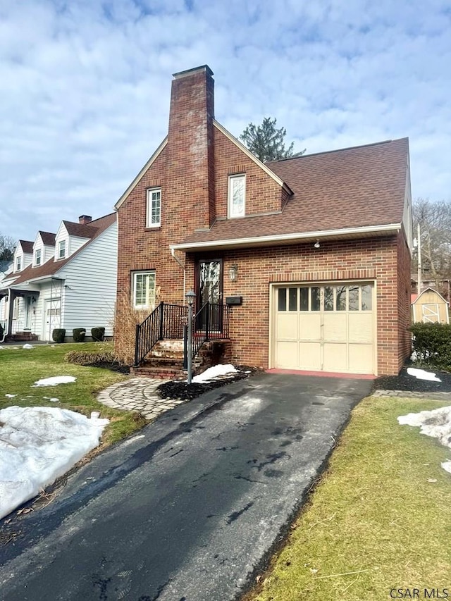 view of front of home with a garage and a front lawn