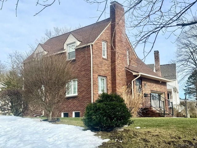 snow covered property featuring a lawn