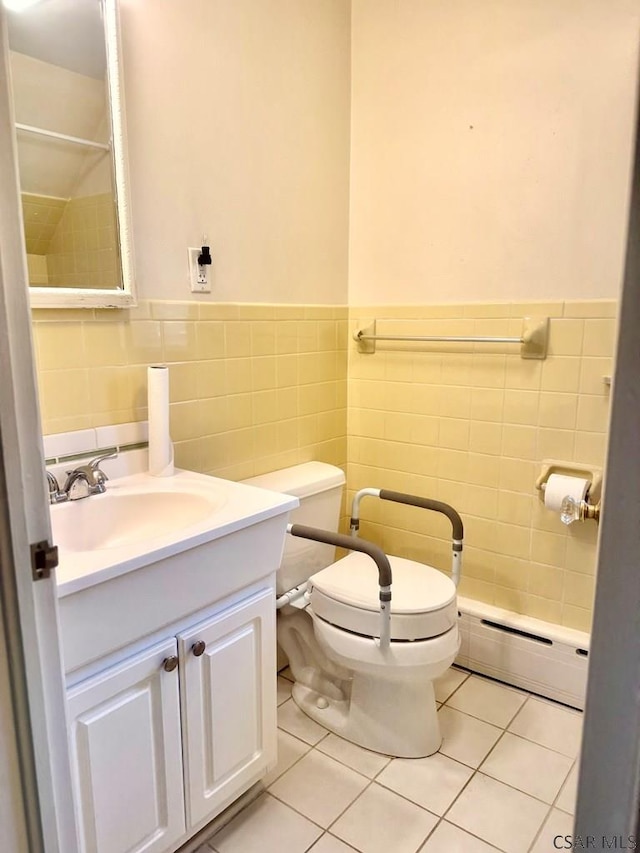 bathroom with tile patterned flooring, a baseboard heating unit, vanity, and toilet