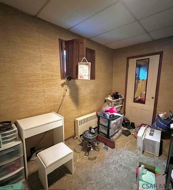 520 Highland Ave, Connellsville, PA 15425 - misc room featuring a paneled ceiling, radiator heating unit, and wood walls