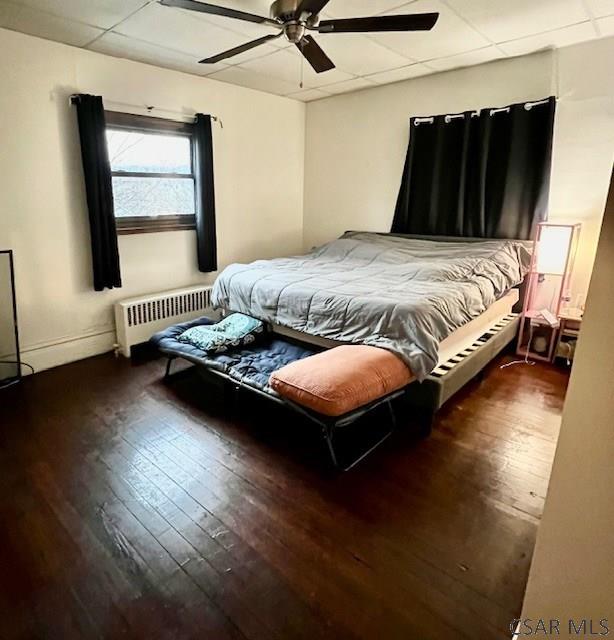 520 Highland Ave, Connellsville, PA 15425 - bedroom with a drop ceiling, radiator heating unit, dark hardwood / wood-style floors, and ceiling fan