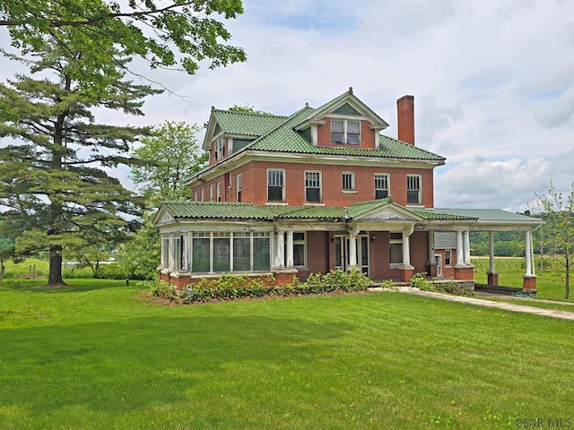 9252 Mason Dixon Hwy, Salisbury, PA 15558 - victorian house featuring a chimney, covered porch, a front lawn, and brick siding