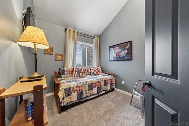 carpeted bedroom with lofted ceiling and baseboards