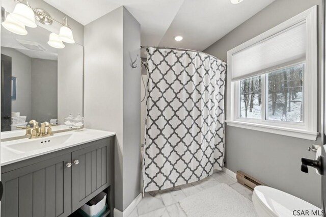 bathroom with marble finish floor, toilet, a baseboard heating unit, vanity, and baseboards