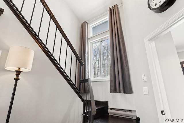 stairway featuring a baseboard radiator