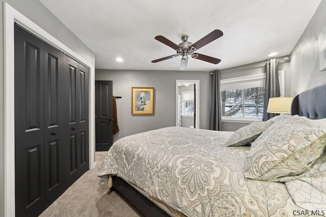 carpeted bedroom with a ceiling fan and a closet