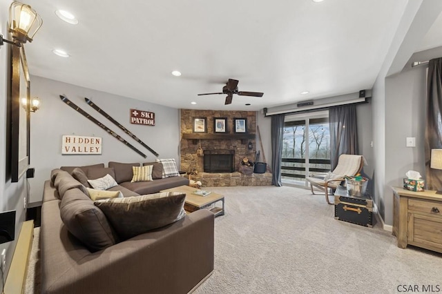 living room with recessed lighting, carpet flooring, ceiling fan, and a stone fireplace