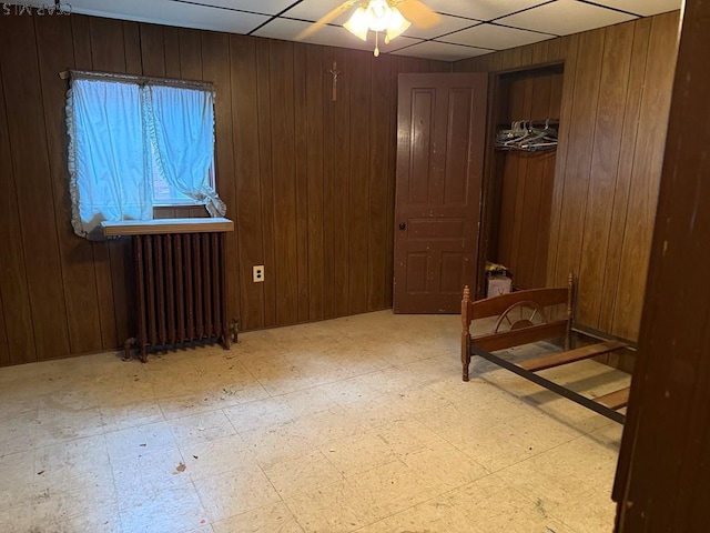 604-606 Grove Ave, Johnstown, PA 15902 - bedroom with radiator, wood walls, light flooring, and a drop ceiling