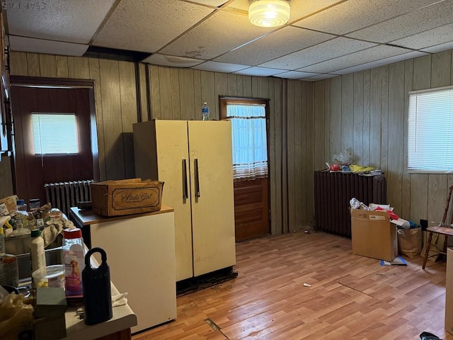 604-606 Grove Ave, Johnstown, PA 15902 - kitchen with radiator, freestanding refrigerator, light wood-style flooring, wood walls, and plenty of natural light