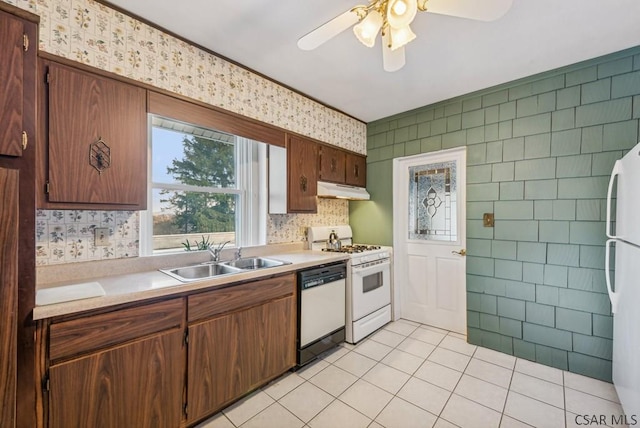 kitchen featuring ceiling fan, sink, light tile patterned floors, and white appliances