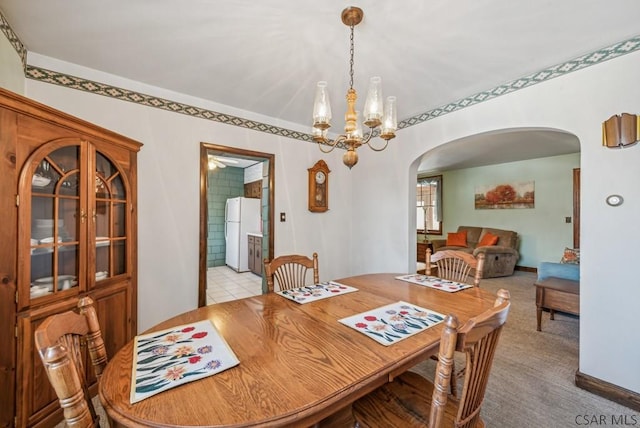 tiled dining space featuring a chandelier