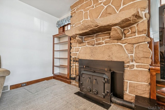 interior details featuring a fireplace and carpet