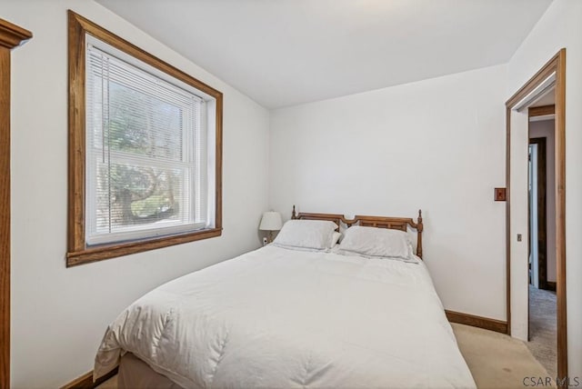 bedroom featuring light carpet