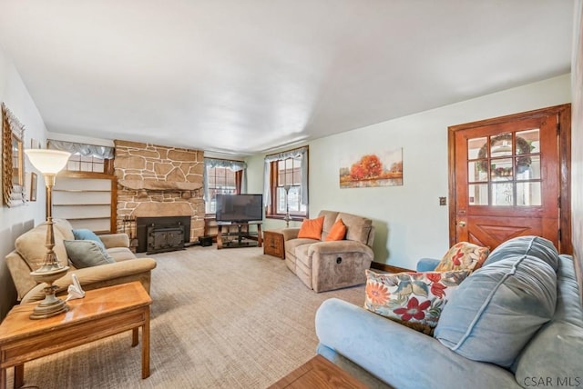 living room featuring a stone fireplace