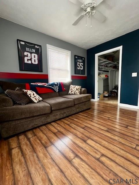 living room with hardwood / wood-style flooring and ceiling fan