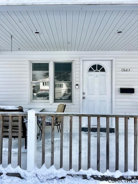 view of snow covered property entrance