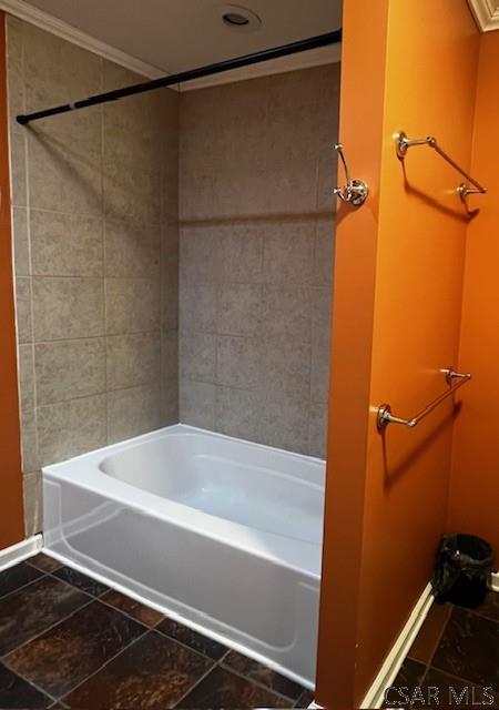 bathroom featuring washtub / shower combination and ornamental molding