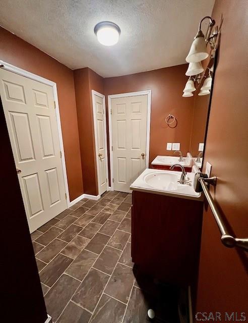 bathroom featuring vanity and a textured ceiling