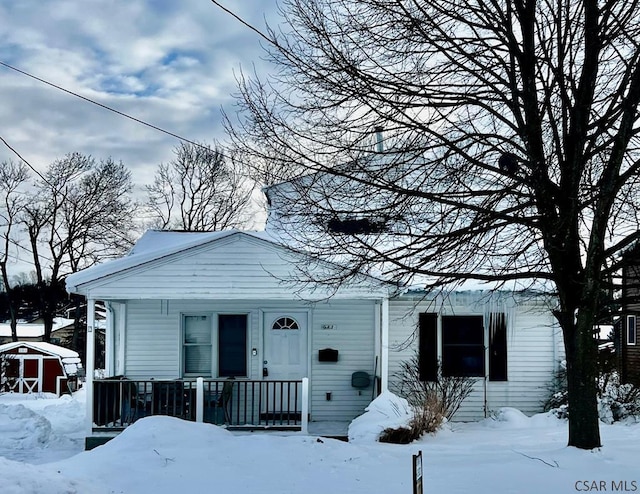 view of front of property with a storage shed