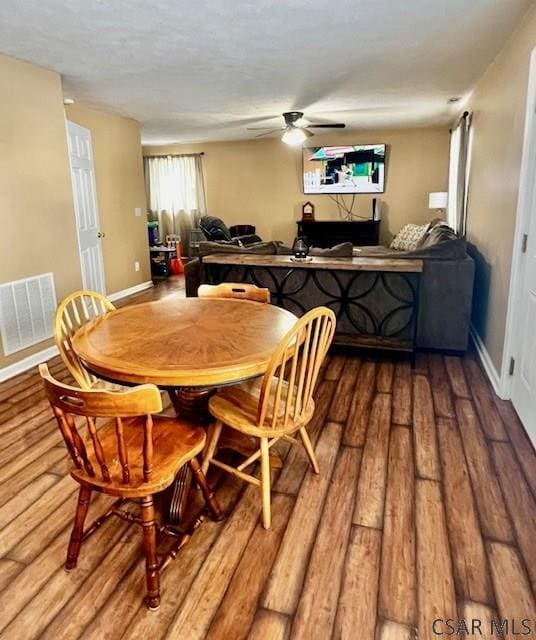 dining space with hardwood / wood-style flooring and ceiling fan