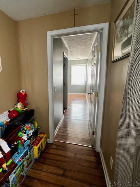 corridor featuring dark wood-type flooring