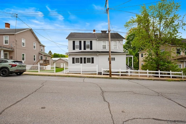view of front of house with a fenced front yard and a residential view