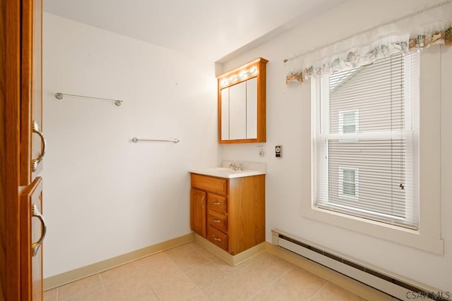 bathroom with a baseboard radiator, tile patterned flooring, vanity, and baseboards