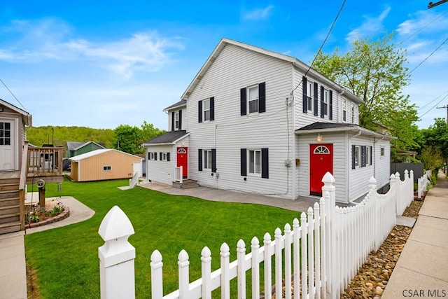 view of front of house featuring entry steps, an outbuilding, and a deck