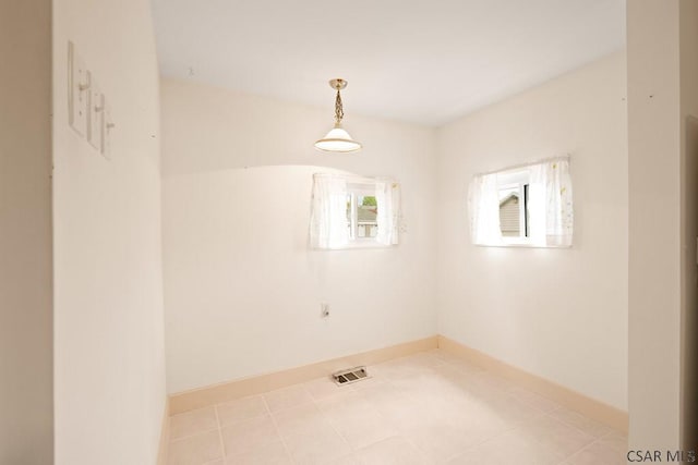 spare room with baseboards