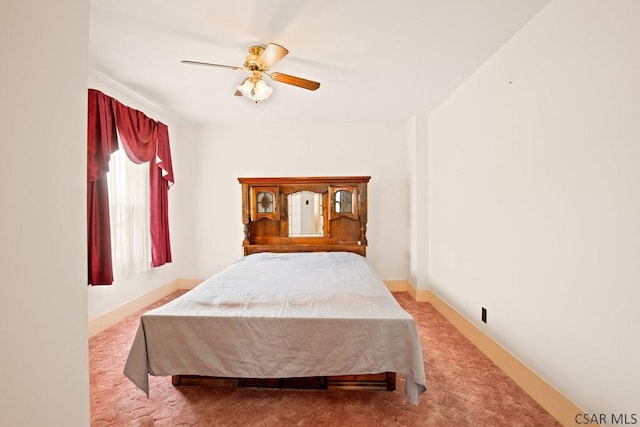 bedroom with carpet flooring, a ceiling fan, and baseboards