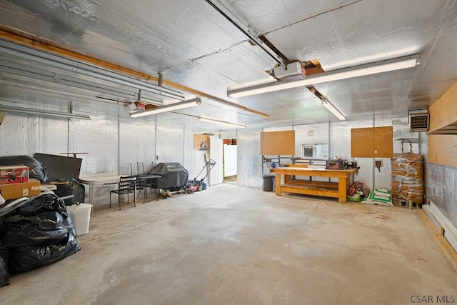 garage with a garage door opener and a workshop area