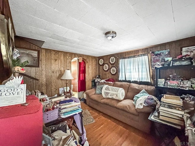2005 Puritan Rd, Portage, PA 15946 - living room featuring wood finished floors, wooden walls, and arched walkways
