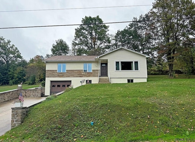 view of front of home with a garage and a front yard