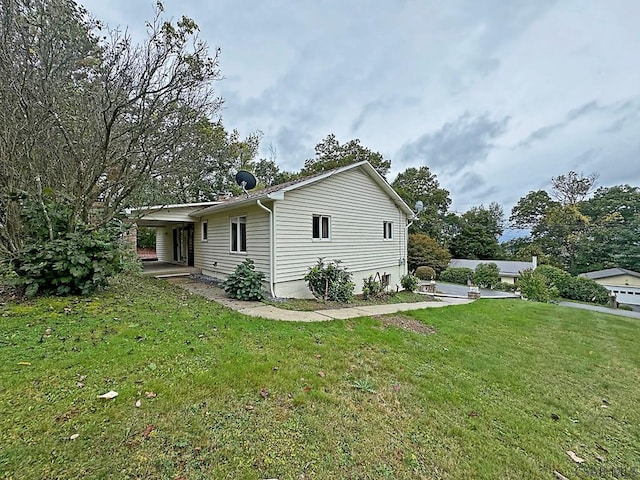 view of side of property with a yard