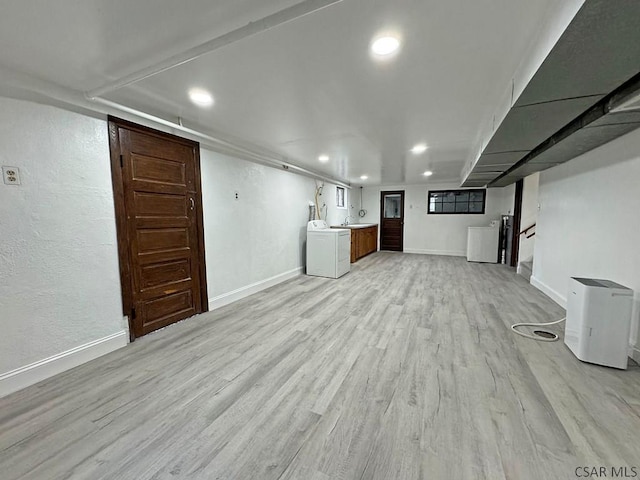 basement featuring washer / clothes dryer and light hardwood / wood-style flooring